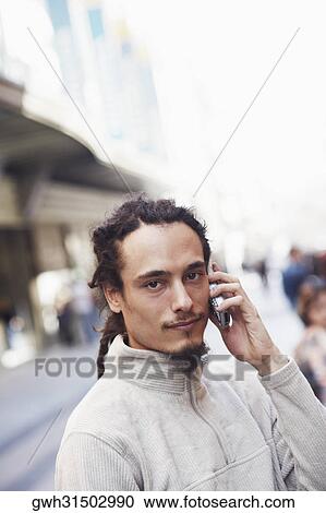 Portrait of a young man talking on a mobile phone View Large Photo Image Stock Image - Portrait of a young man talking on a mobile phone . Fotosearch