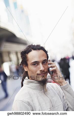 Portrait of a young man talking on a mobile phone View Large Photo Image Stock Image - Portrait of a young man talking on a mobile phone . Fotosearch