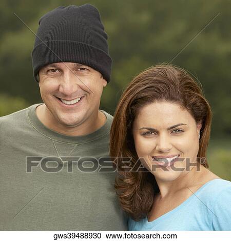 Stock Image - Portrait of a young woman and a mature man smiling. Fotosearch