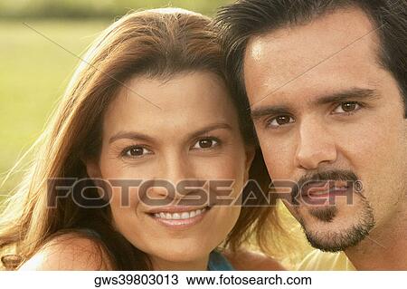 Portrait of a young woman and a mature man smiling View Large Photo Image Stock Image - Portrait of a young woman and a mature man smiling. Fotosearch