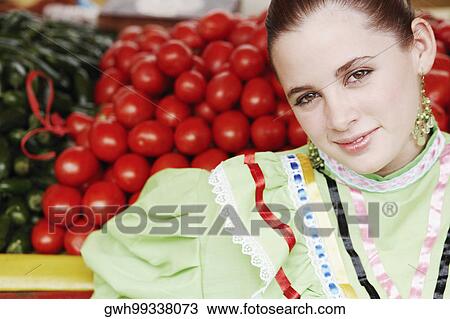 Portrait of a young woman at a market stall View Large Photo Image Stock Image - Portrait of a young woman at a market stall. Fotosearch