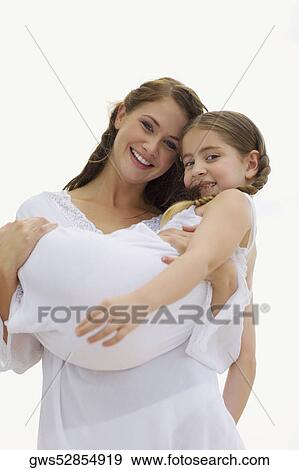 Portrait of a young woman carrying her daughter and smiling View Large Photo Image Stock Photo - Portrait of a young woman carrying her daughter and smiling. Fotosearch