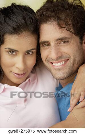Portrait of a young woman embracing a mid adult man View Large Photo Image Stock Photography - Portrait of a young woman embracing a mid adult man. Fotosearch