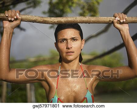 Portrait of a young woman holding a log View Large Photo Image Stock Image - Portrait of a young woman holding a log. Fotosearch