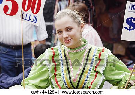 Portrait of a young woman in a market View Large Photo Image Stock Image - Portrait of a young woman in a market. Fotosearch