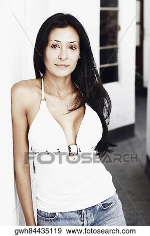 Portrait of a young woman leaning against a wall View Large Photo Image Stock Photo - Portrait of a young woman leaning against a wall. Fotosearch