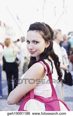 Portrait of a young woman looking back View Large Photo Image Stock Photograph - Portrait of a young woman looking back . Fotosearch