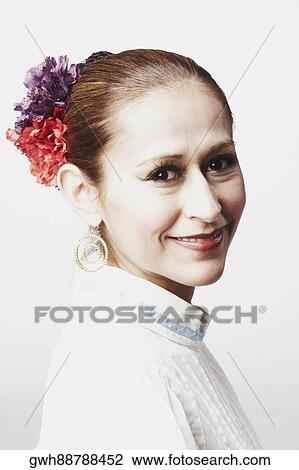 Stock Image - Portrait of a young woman posing and smiling. Fotosearch