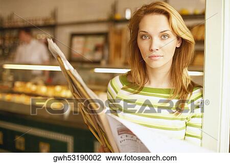 Portrait of a young woman reading a menu card View Large Photo Image Stock Image - Portrait of a young woman reading a menu card . Fotosearch