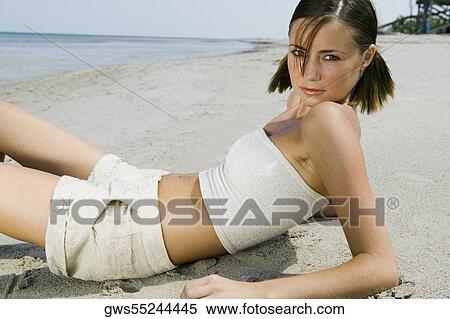 Portrait of a young woman reclining on the beach View Large Photo Image Stock Photography - Portrait of a young woman reclining on the beach. Fotosearch