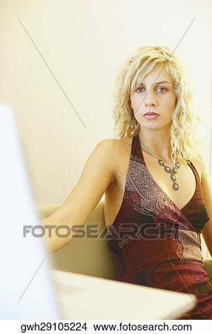 Picture - Portrait of a young woman sitting in an armchair. Fotosearch