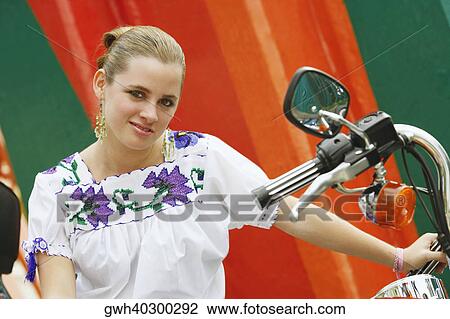 Portrait of a young woman sitting on a motorcycle View Large Photo Image Stock Image - Portrait of a young woman sitting on a motorcycle. Fotosearch