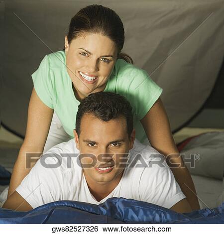 Portrait of a young woman sitting on a young man's back View Large Photo Image Stock Photograph - Portrait of a young woman sitting on a young man's back. Fotosearch