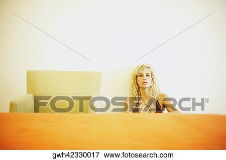 Portrait of a young woman sitting View Large Photo Image Stock Photo - Portrait of a young woman sitting. Fotosearch