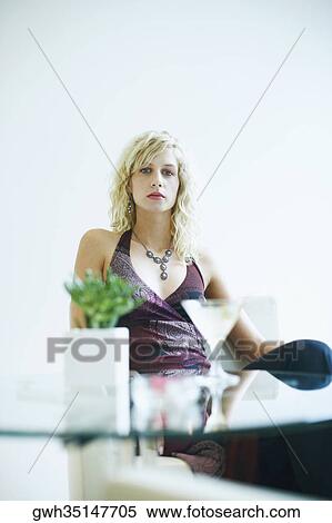 Portrait of a young woman sitting View Large Photo Image Stock Photography - Portrait of a young woman sitting. Fotosearch