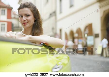 Portrait of a young woman smiling in a car View Large Photo Image Stock Photo - Portrait of a young woman smiling in a car . Fotosearch