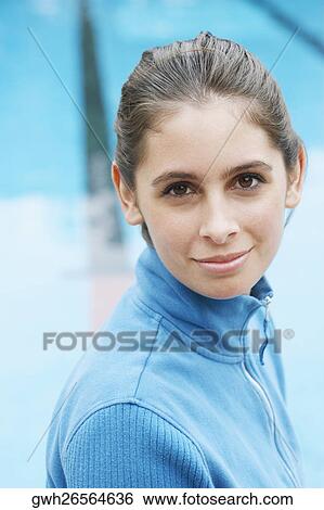 Portrait of a young woman smiling near a swimming pool View Large Photo Image Stock Photograph - Portrait of a young woman smiling near a swimming pool. Fotosearch