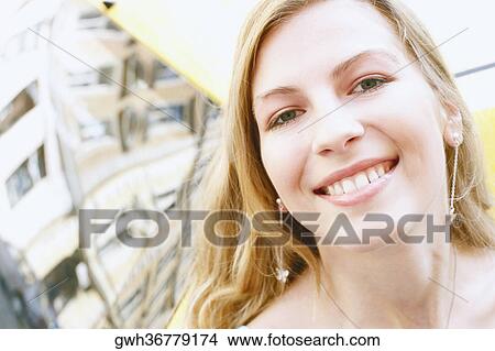 Portrait of a young woman smiling View Large Photo Image Picture - Portrait of a young woman smiling. Fotosearch