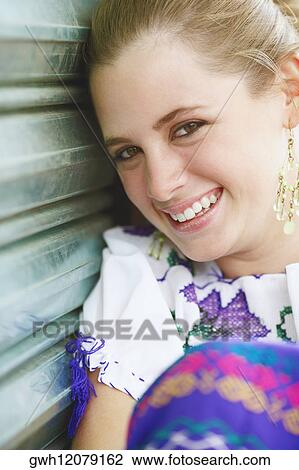 Stock Image - Portrait of a young woman smiling. Fotosearch