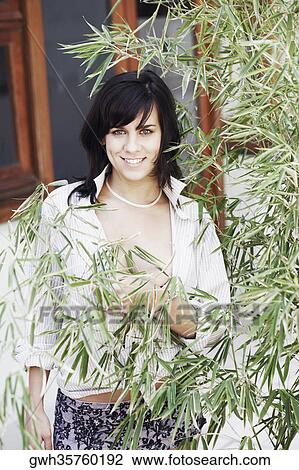 Portrait of a young woman smiling View Large Photo Image Stock Image - Portrait of a young woman smiling. Fotosearch