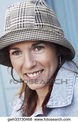 Portrait of a young woman smiling View Large Photo Image Stock Photo - Portrait of a young woman smiling. Fotosearch