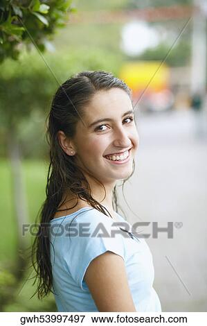 Stock Photo - Portrait of a young woman smiling. Fotosearch