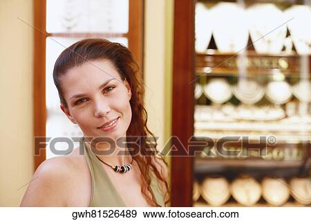 Portrait of a young woman smiling View Large Photo Image Stock Photo - Portrait of a young woman smiling. Fotosearch