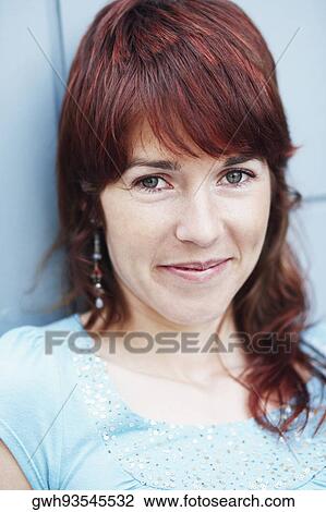 Portrait of a young woman smirking View Large Photo Image Stock Image - Portrait of a young woman smirking. Fotosearch