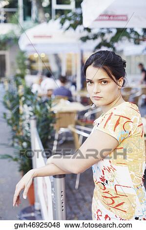 Stock Photo - Portrait of a young woman standing . Fotosearch