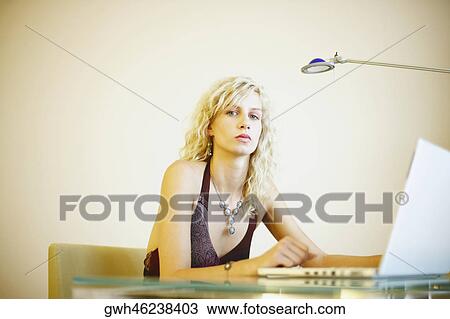 Portrait of a young woman using a laptop View Large Photo Image Stock Image - Portrait of a young woman using a laptop. Fotosearch