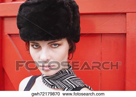 Stock Image - Portrait of a young woman wearing a fur hat. Fotosearch
