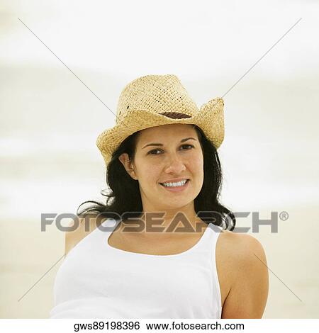 Stock Photograph - Portrait of a young woman wearing a sun hat. Fotosearch