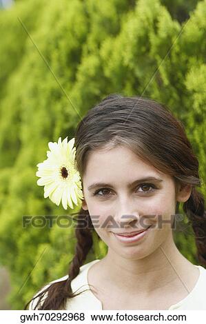 Portrait of a young woman wearing flowers View Large Photo Image Stock Photo - Portrait of a young woman wearing flowers. Fotosearch
