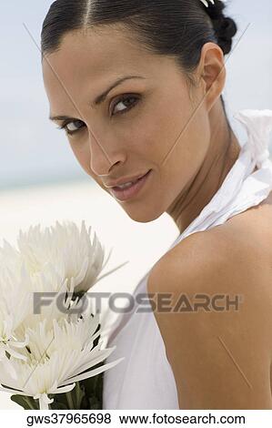 Stock Photo - Portrait of a young woman with flowers. Fotosearch