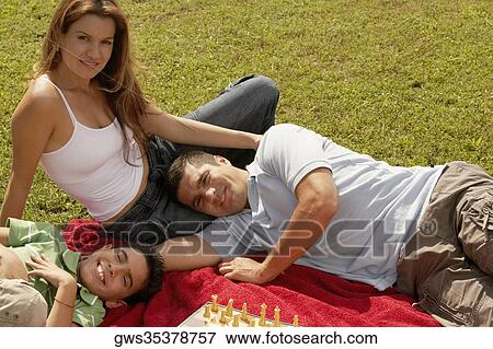 Portrait of parents and their son looking cheerful View Large Photo Image Stock Photo - Portrait of parents and their son looking cheerful. Fotosearch