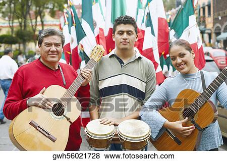 Stock Photo - Portrait of three musicians standing with their musical instruments. Fotosearch