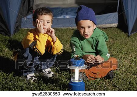 Portrait of two boys sitting together in front of a tent View Large Photo Image Stock Image - Portrait of two boys sitting together in front of a tent. Fotosearch