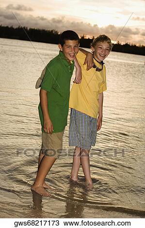 Portrait of two boys standing on the beach View Large Photo Image Stock Image - Portrait of two boys standing on the beach. Fotosearch