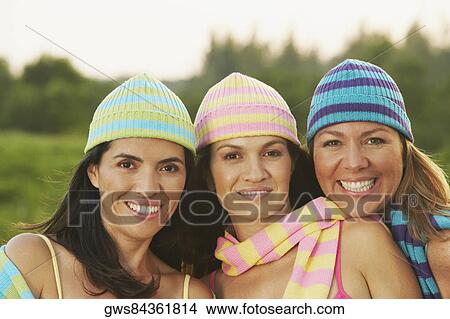 Picture - Portrait of two mid adult women and a mature woman smiling. Fotosearch