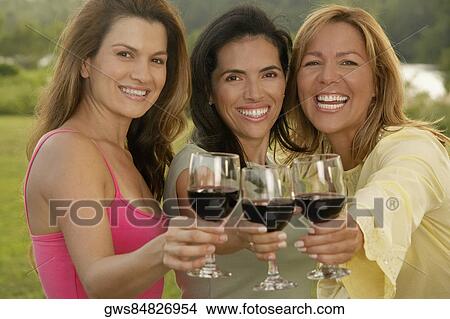 Portrait of two mid adult women and a mature woman holding wine glasses View Large Photo Image Picture - Portrait of two mid adult women and a mature woman holding wine glasses. Fotosearch