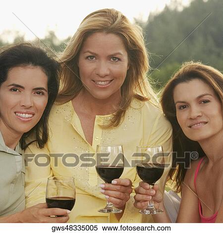 Portrait of two mid adult women and a mature woman holding wine glasses View Large Photo Image Stock Photography - Portrait of two mid adult women and a mature woman holding wine glasses. Fotosearch