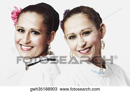 Portrait of two young women posing and smiling View Large Photo Image Stock Image - Portrait of two young women posing and smiling. Fotosearch