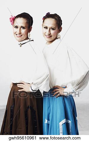 Stock Image - Portrait of two young women posing together. Fotosearch