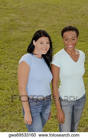 Portrait of two young women smiling View Large Photo Image Stock Image - Portrait of two young women smiling. Fotosearch