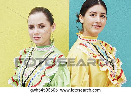 Portrait of two young women standing together and smiling View Large Photo Image Stock Photography - Portrait of two young women standing together and smiling. Fotosearch