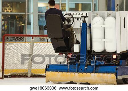 Rear view of a person sitting on an ice resurfacing machine View Large Photo Image Stock Photograph - Rear view of a person sitting on an ice resurfacing machine. Fotosearch