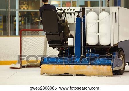 Rear view of a person sitting on an ice resurfacing machine View Large Photo Image Stock Photography - Rear view of a person sitting on an ice resurfacing machine. Fotosearch