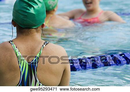 Rear view of a woman in a swimming pool View Large Photo Image Stock Image - Rear view of a woman in a swimming pool. Fotosearch