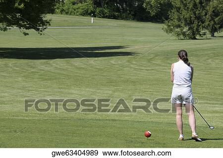 Rear view of a woman playing golf View Large Photo Image Stock Photo - Rear view of a woman playing golf. Fotosearch