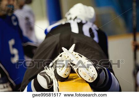 Rear view of an ice hockey player lying on a railing View Large Photo Image Stock Photo - Rear view of an ice hockey player lying on a railing. Fotosearch